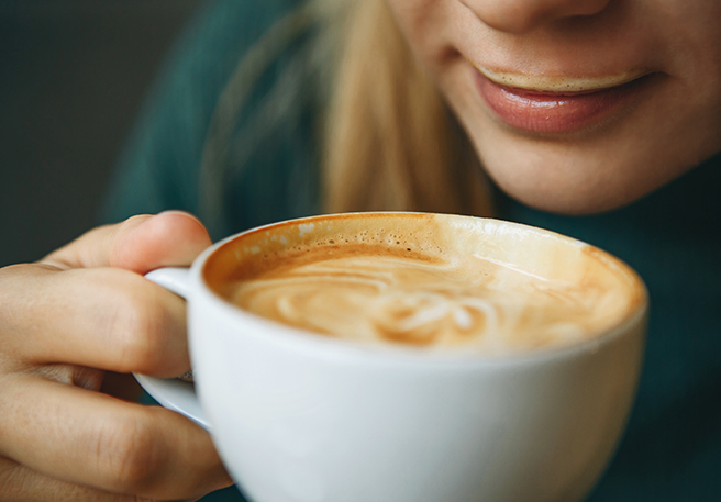 Frau genießt Milchkaffee